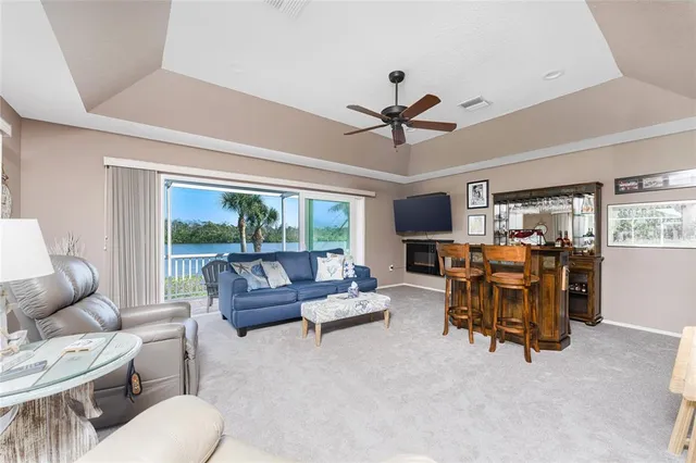 a living room with furniture a flat screen tv and a table