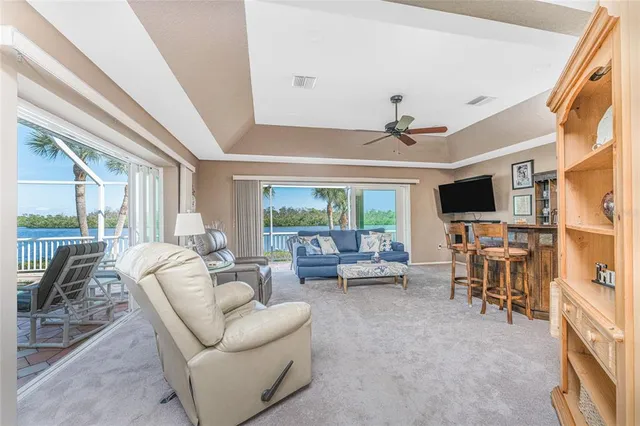 a dining room with furniture a chandelier and wooden floor