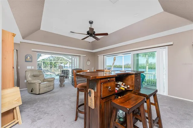 a view of a dining room with furniture large windows and wooden floor
