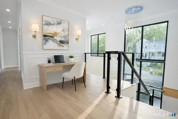 a view of a livingroom with furniture window and wooden floor
