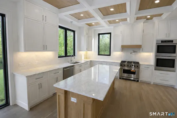 a kitchen with a sink a counter top space and stainless steel appliances