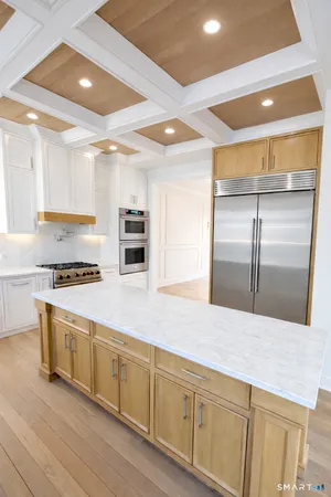 a kitchen with stainless steel appliances granite countertop a stove a sink and a refrigerator