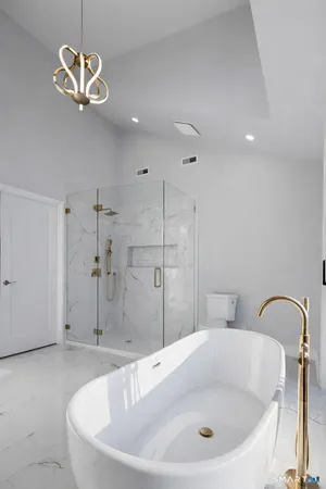 a bathroom with a bathtub and a shower