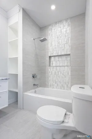 a bathroom with a toilet bathtub and shower