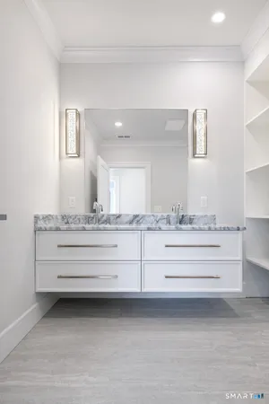 a bathroom with sink mirror and vanity