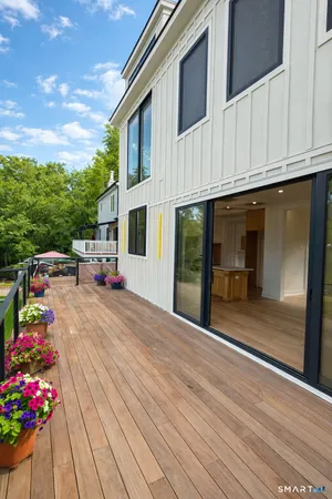 a view of white house with a potted plant