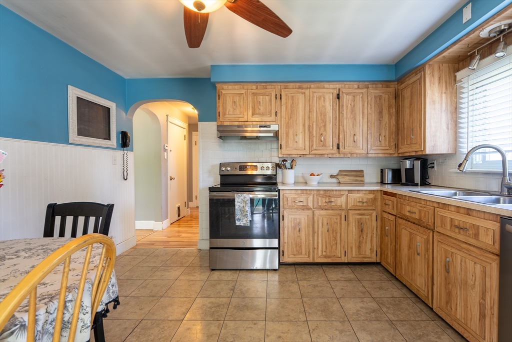 110 James M Beardsworth Road Tiverton, RI 02878 - Photo 15 of 26 a kitchen with stainless steel appliances granite countertop a stove a sink a microwave and a refrigerator