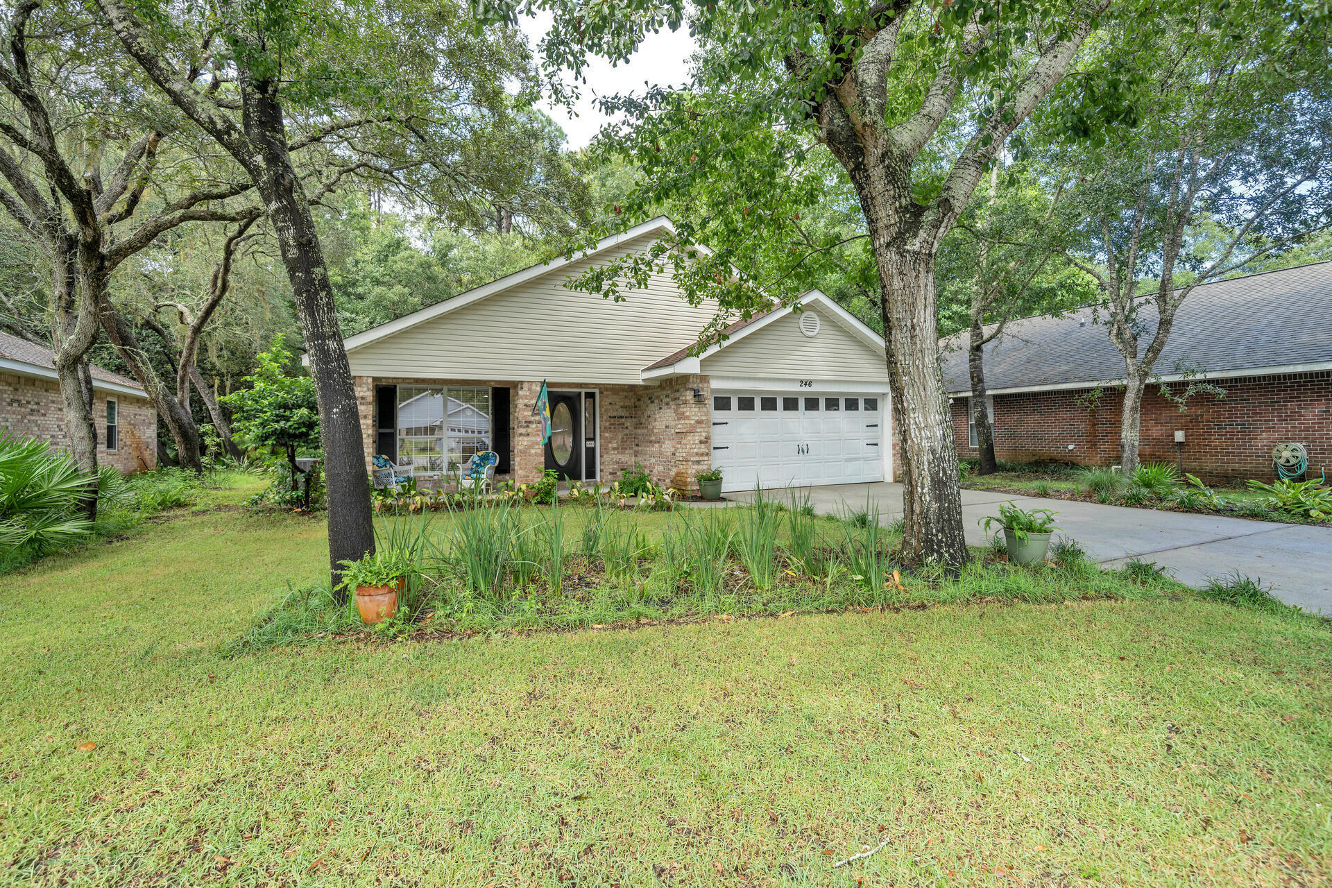 246 Bayou Landing Road Santa Rosa Beach, FL 32459 - Photo 24 of 29 a front view of a house with garden