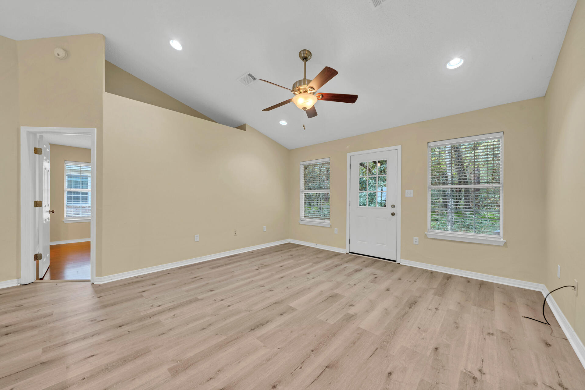 246 Bayou Landing Road Santa Rosa Beach, FL 32459 - Photo 8 of 29 a view of an empty room with a window and wooden floor