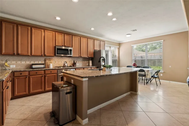 a kitchen with a sink stove and cabinets