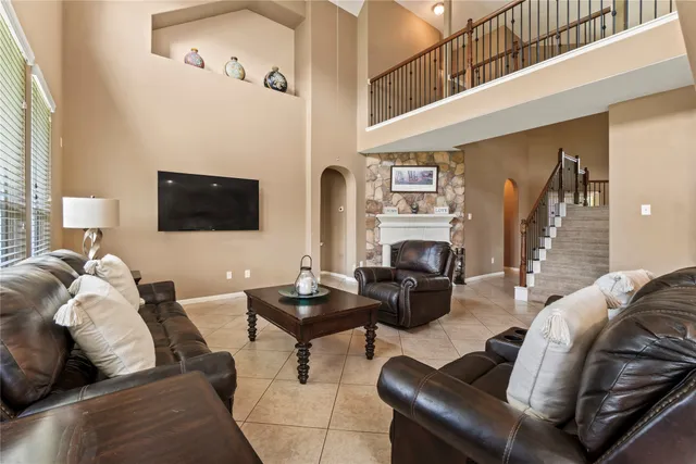 a living room with fireplace furniture and a flat screen tv