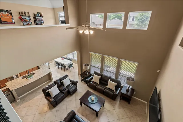 a living room with furniture and floor to ceiling window