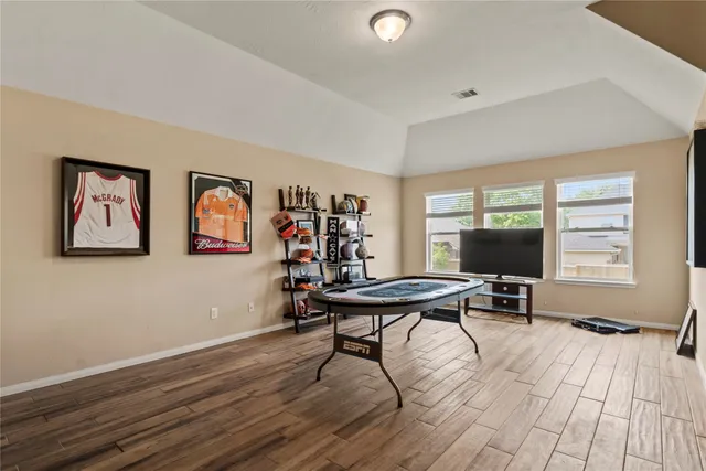 a view of a livingroom with furniture window and wooden floor