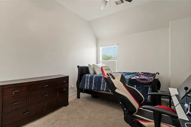 a bedroom with a bed and a dresser