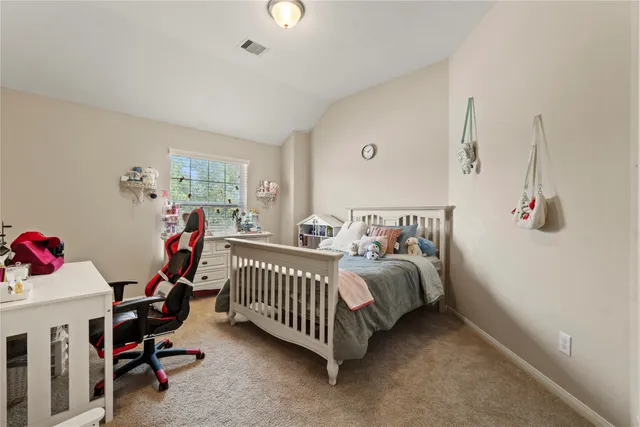 a bedroom with bed and a window