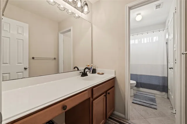 a bathroom with a sink and a mirror with bathtub