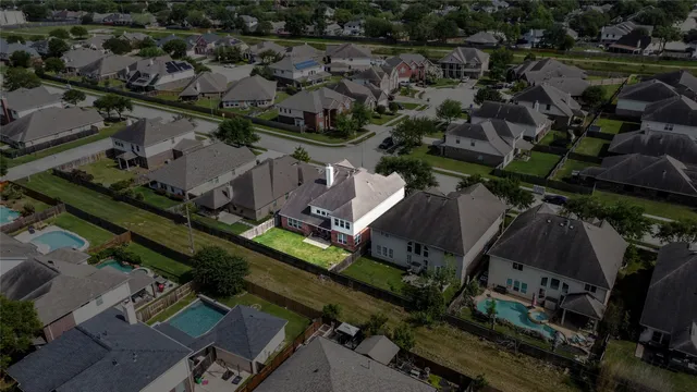 an aerial view of multiple houses with a yard