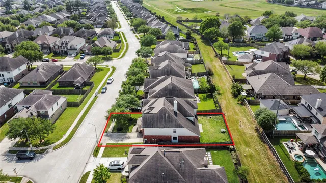 an aerial view of residential houses with outdoor space