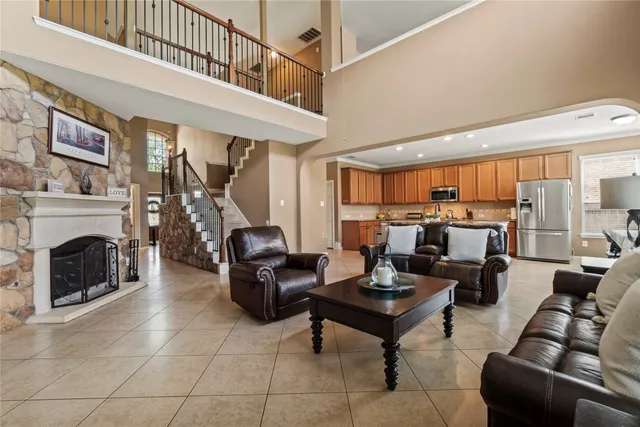 a living room with furniture a fireplace and a chandelier