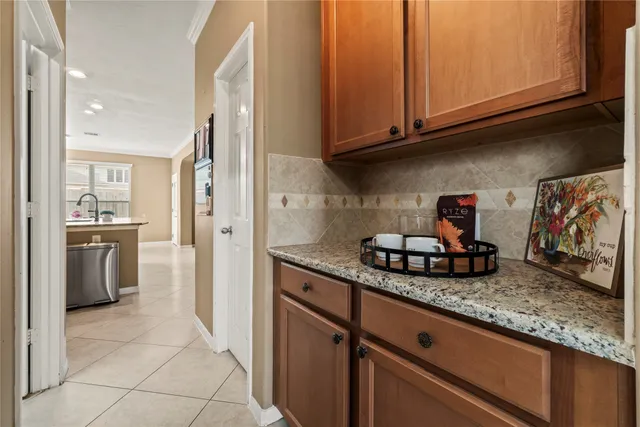 a kitchen with granite countertop a sink and cabinets