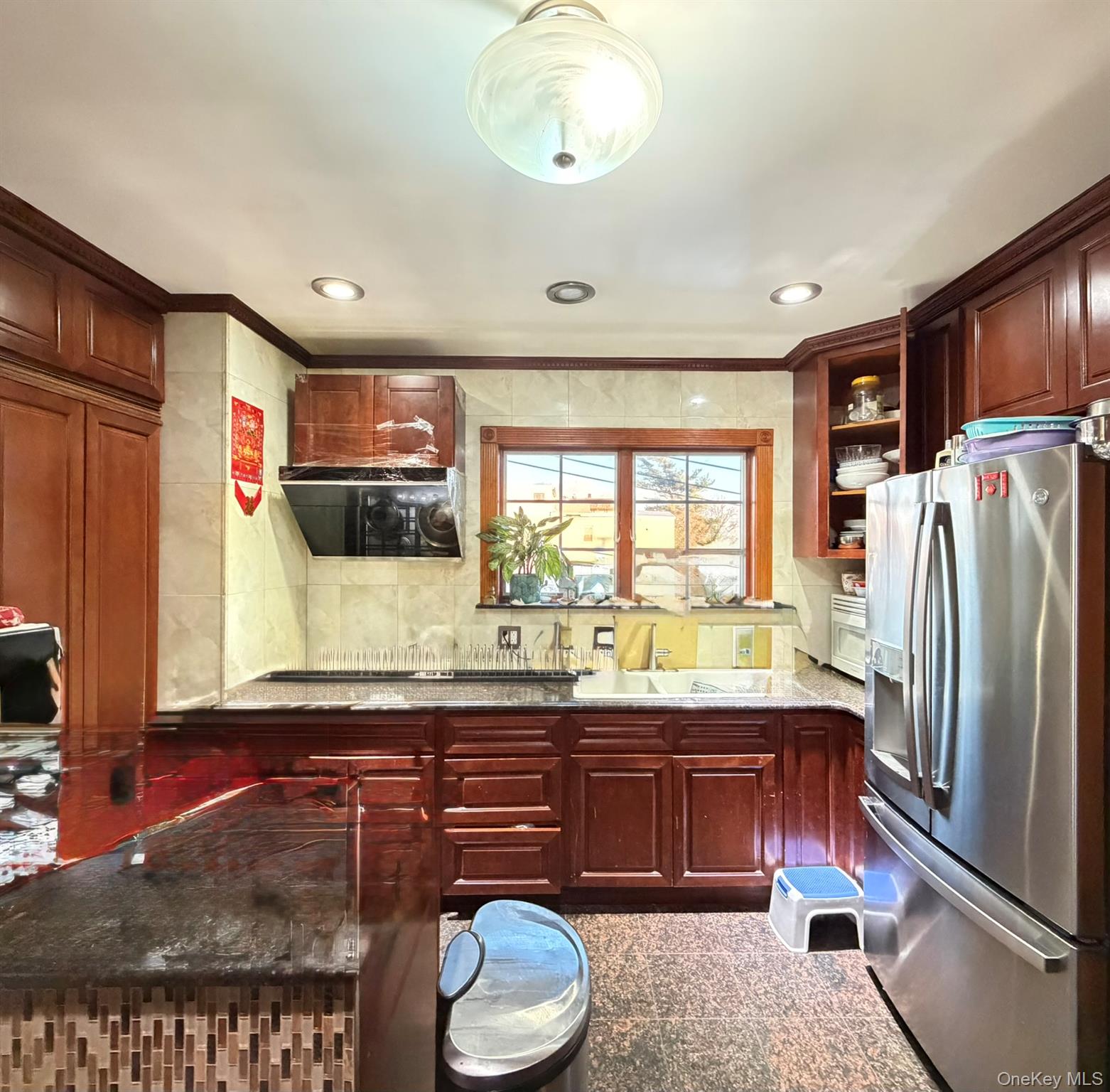 111-20 14th Road Queens, NY 11356 - Photo 5 of 13 a kitchen with a refrigerator and a sink