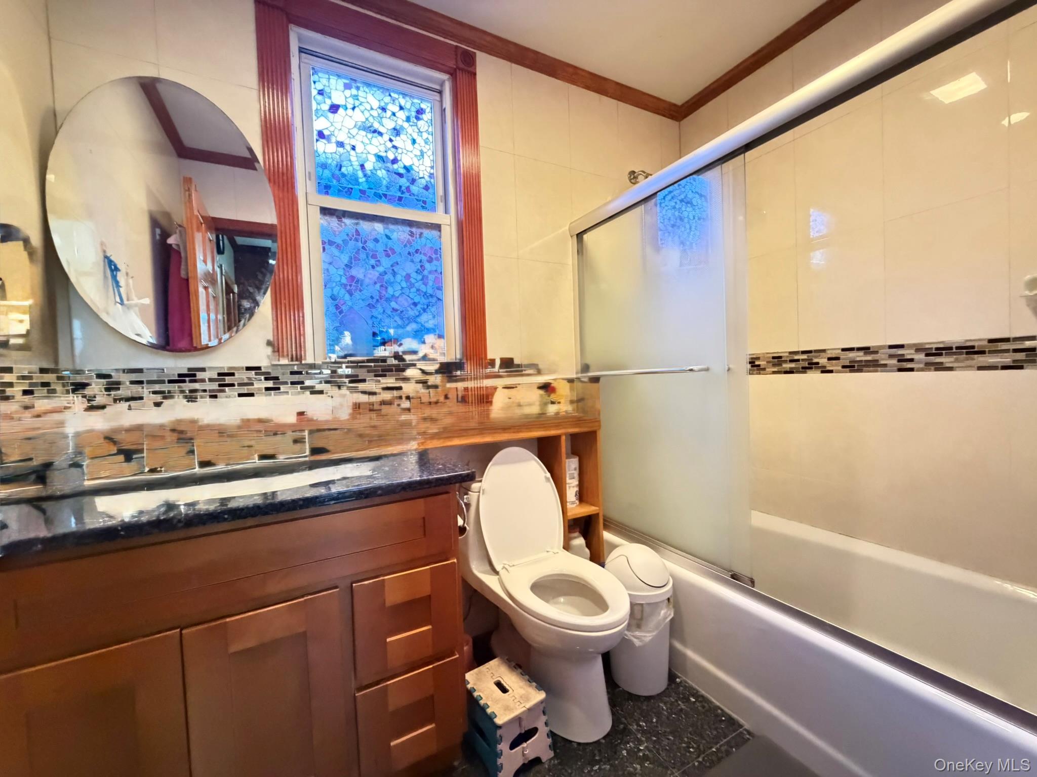 111-20 14th Road Queens, NY 11356 - Photo 6 of 13 a bathroom with a toilet sink and mirror