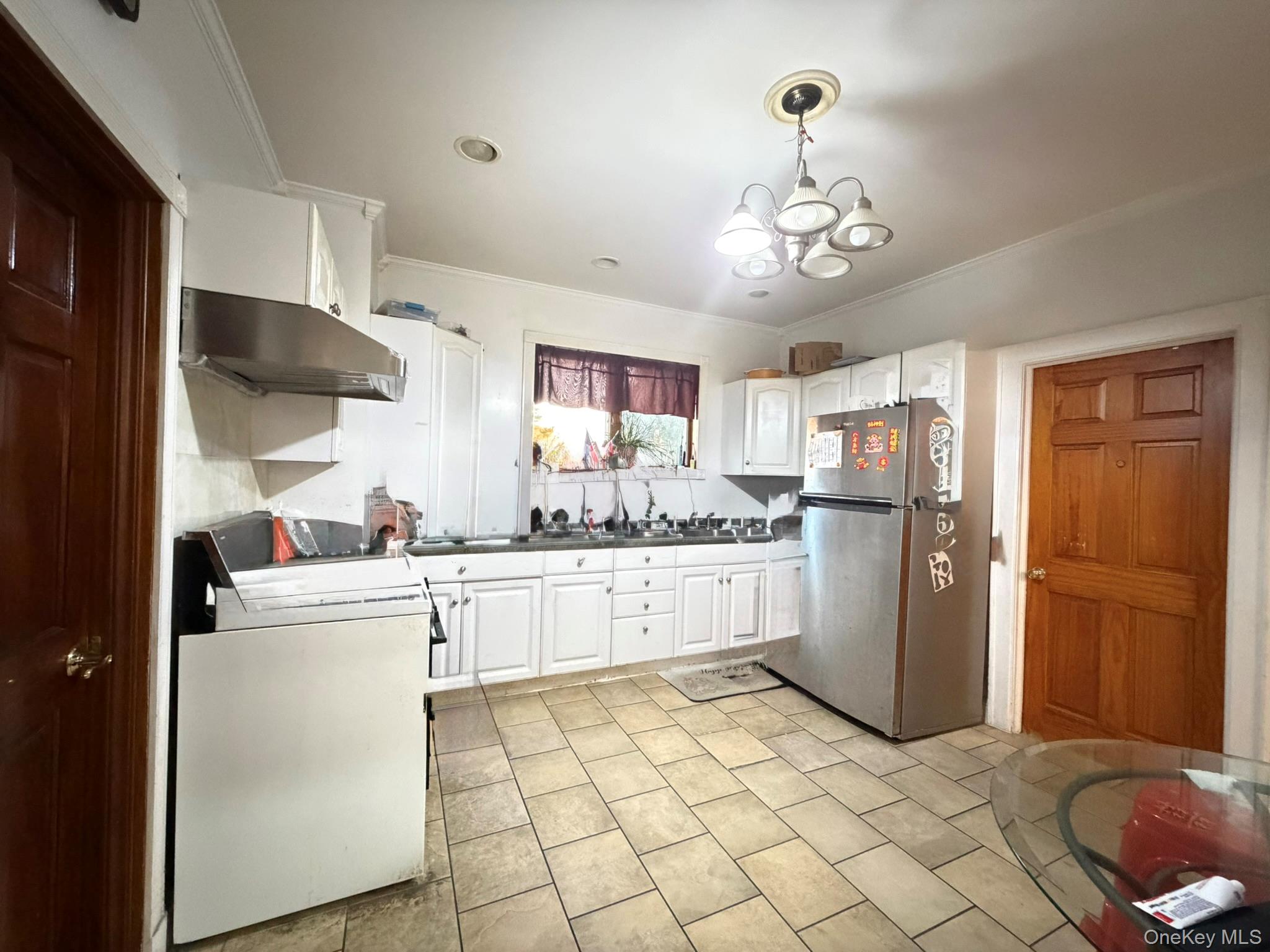 111-20 14th Road Queens, NY 11356 - Photo 8 of 13 a kitchen with a refrigerator sink and cabinets