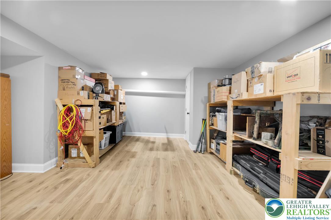 2011 Greenwood Road Allentown, PA 18103 - Photo 41 of 52 Functional basement storage with light wood-tone flooring and ample built-in shelving provides organization.