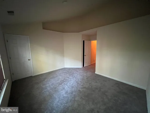 an empty room with a empty space and windows