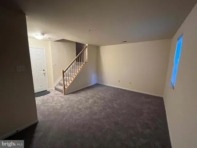 a view of an empty room with stairs
