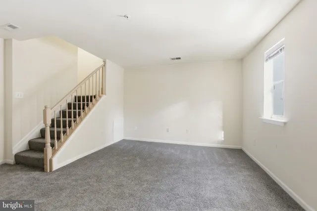 a view of an empty room with stairs