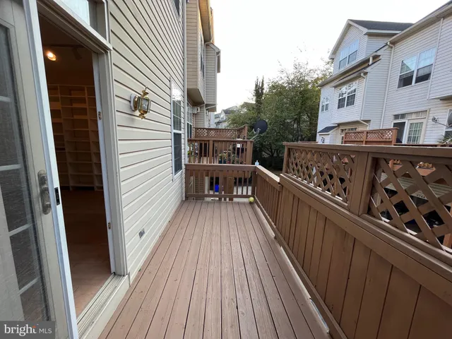 a view of a balcony with wooden floor
