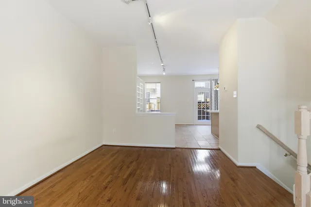 a view of a room with wooden floor and a window