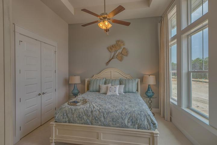 25 W Pine, Unit B Inlet Beach, FL 32461 - Photo 35 of 44 a bedroom with a bed and a chandelier