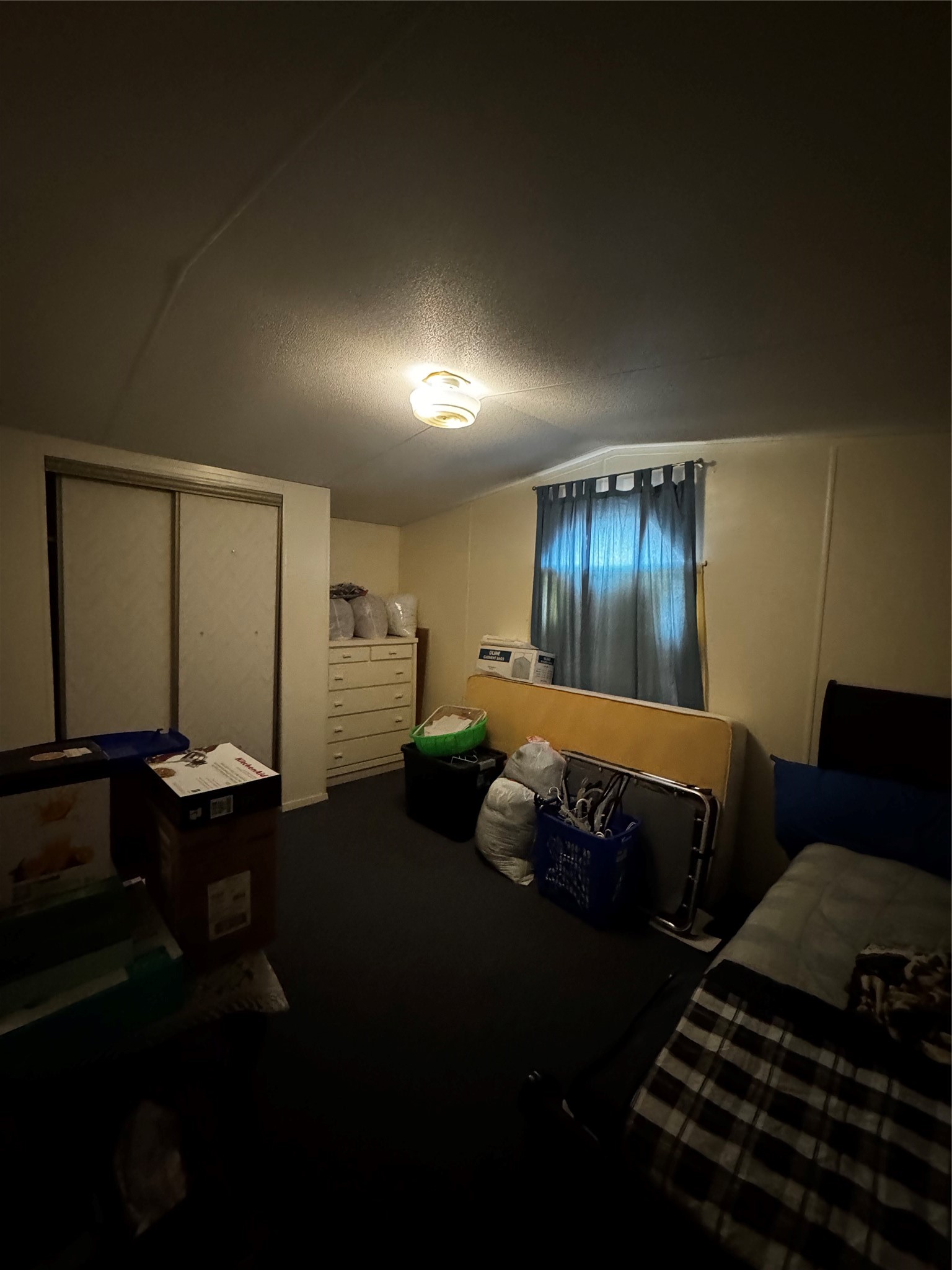 317 12th Street Palacios, TX 77465 - Photo 26 of 31 a spacious bedroom with a bed and a chandelier