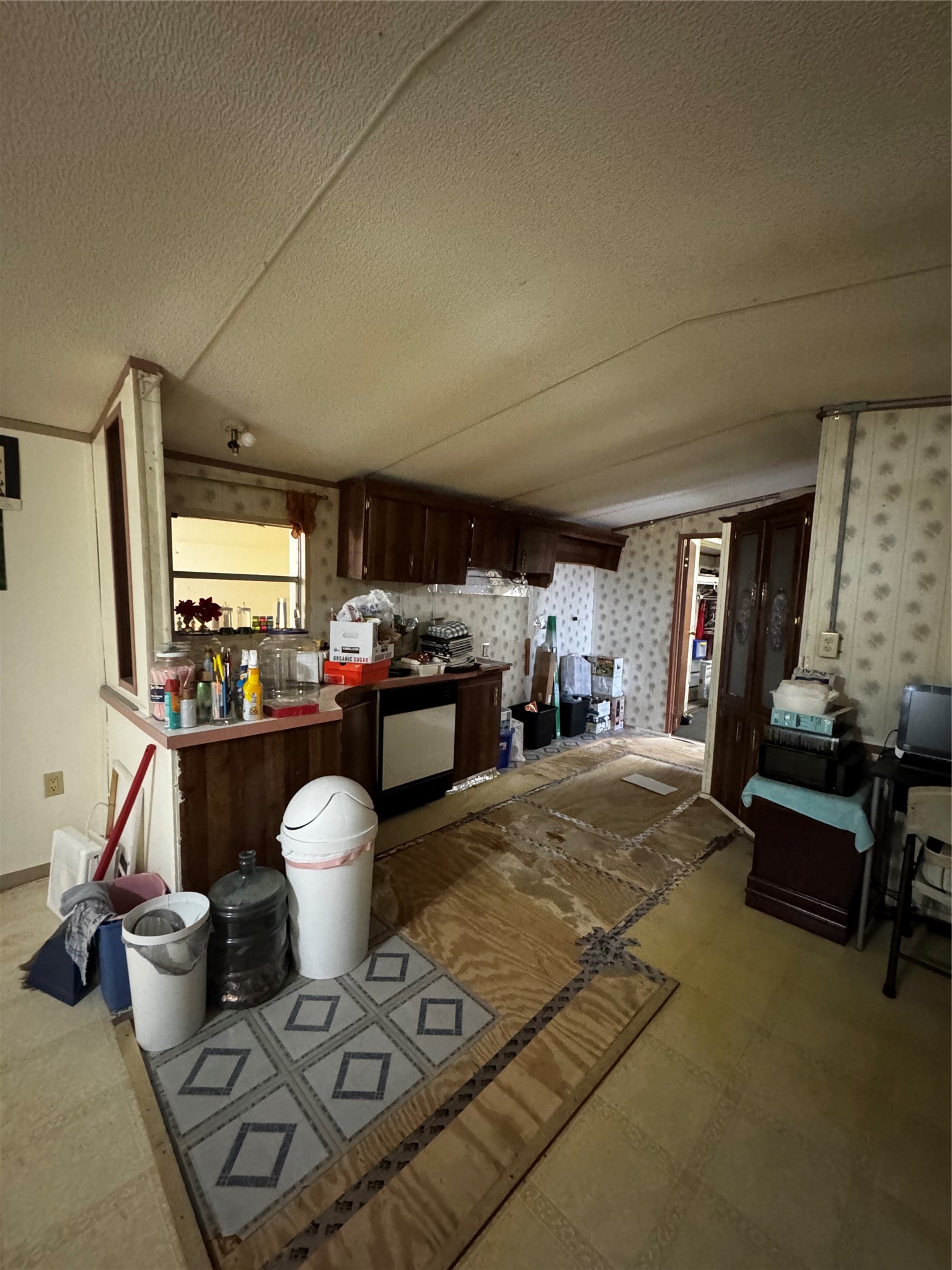 317 12th Street Palacios, TX 77465 - Photo 27 of 31 a living room with furniture a flat screen tv and a refrigerator