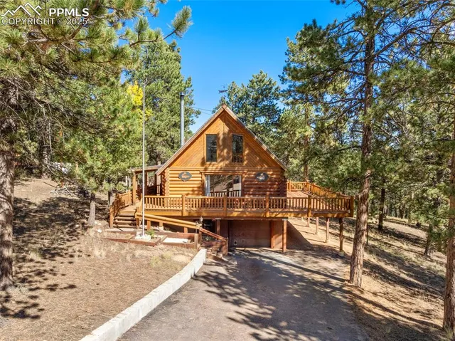 a roof deck with table and chairs under an umbrella