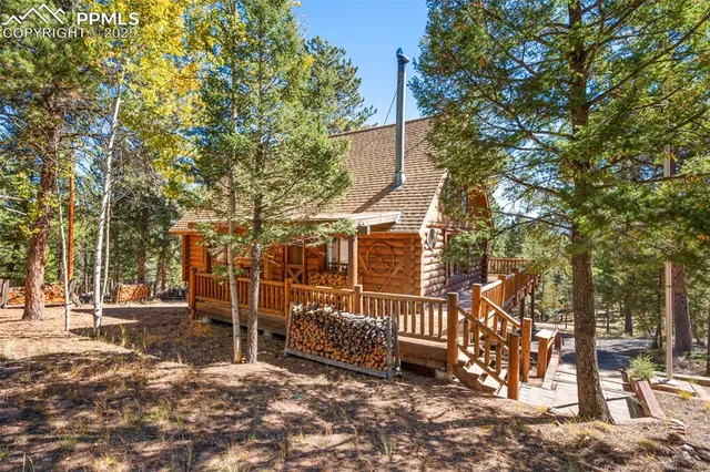 a view of a patio with table and chairs with wooden fence and plants