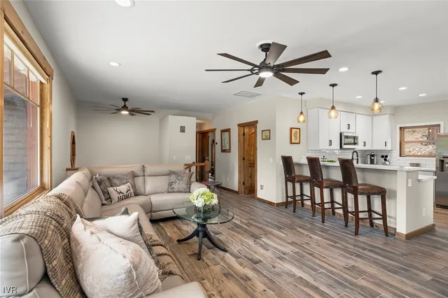 a living room with furniture and a wooden floor
