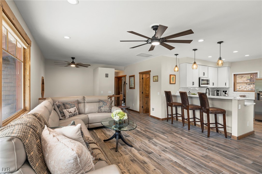a living room with furniture and a wooden floor