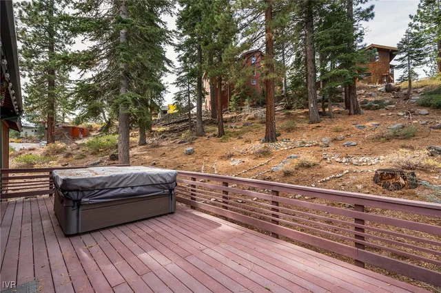 a view of a roof deck with wooden floor and fence