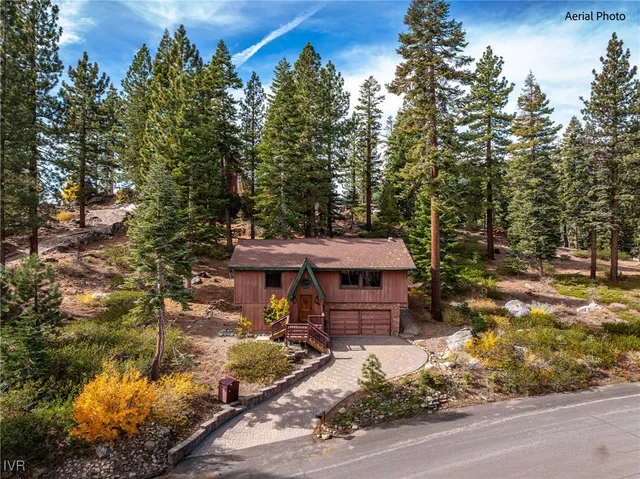 a view of a house with a wooden fence