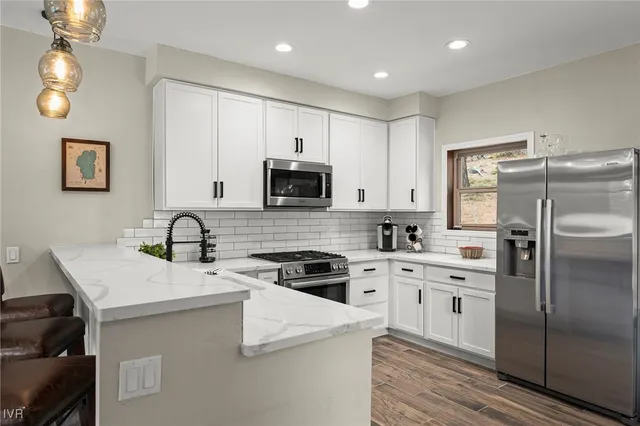 a kitchen with a sink a stove a refrigerator and cabinets