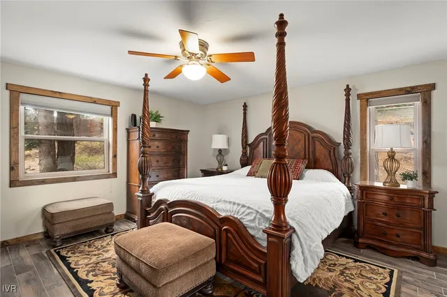 a bedroom with bed and wooden floor