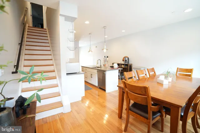 a dining room with furniture and wooden floor