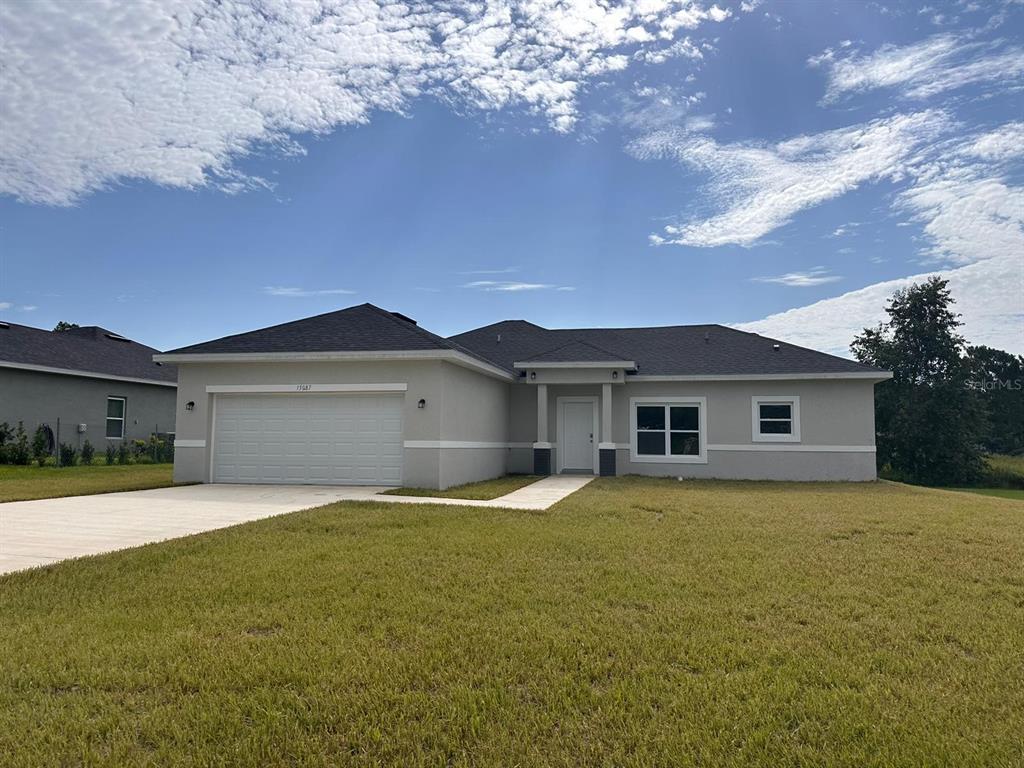15087 Southwest 52nd Court Ocala, FL 34473 - Photo 1 of 1 a white house with a yard and large trees