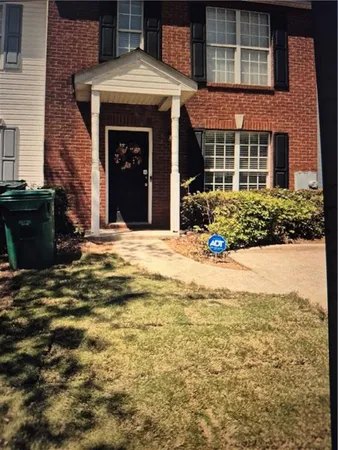 a view of a brick house with many windows