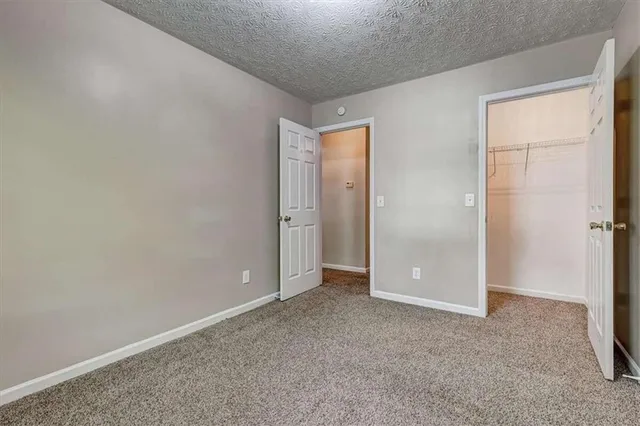 an empty room with closet area