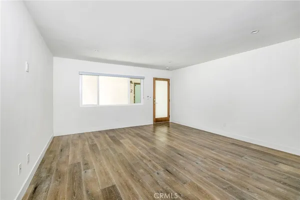 a view of a room with wooden floor and windows