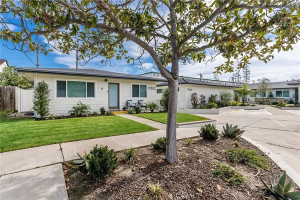 a view of a house with a yard and tree s